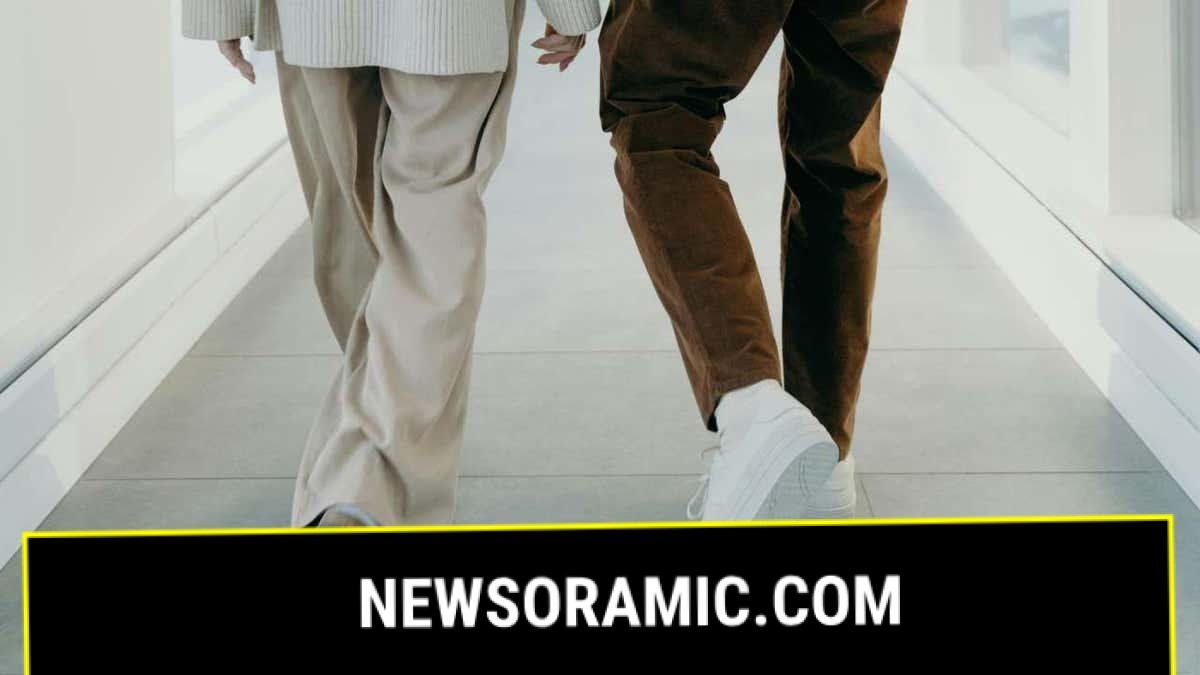 A man and a woman walking indoors