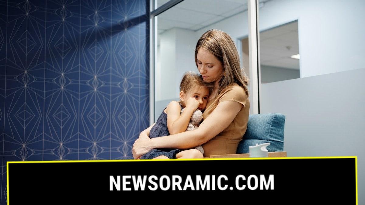 Woman with sick daughter at doctor