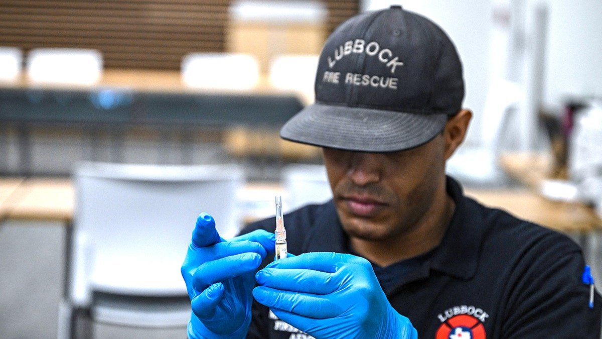 A paramedic administers a dose of the measles vaccine at a health center in Lubbock, Texas
