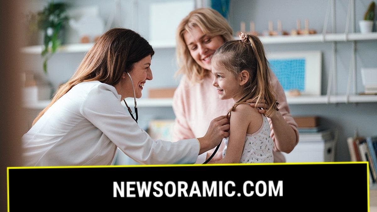 pediatrician examines a girl with her mother