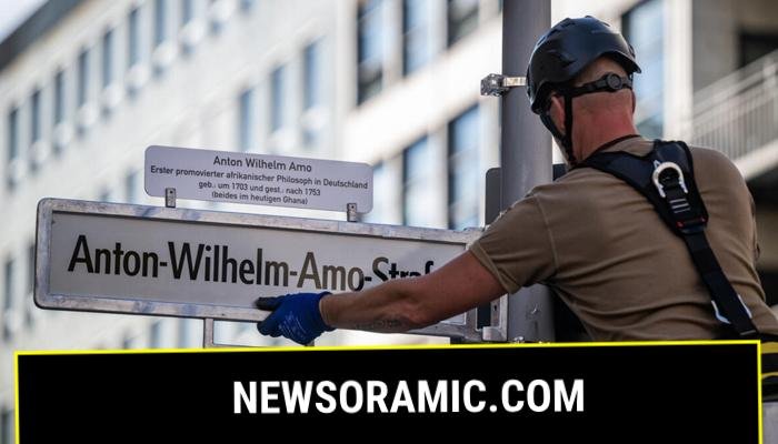 A worker installs a sign with the streets new name, after years of controversy and a last-minute courtroom drama over the old name, Moors Street. — AFP