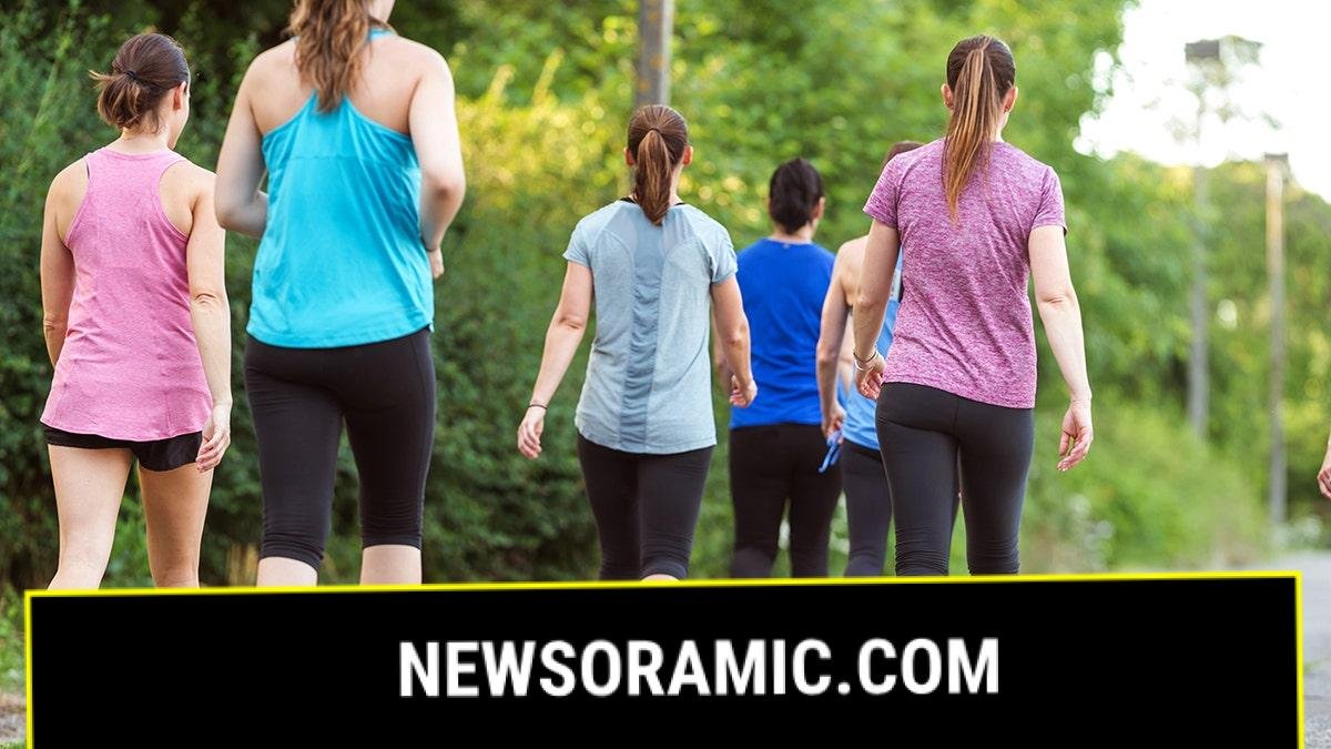 Women walking in a group with their backs facing the camera.