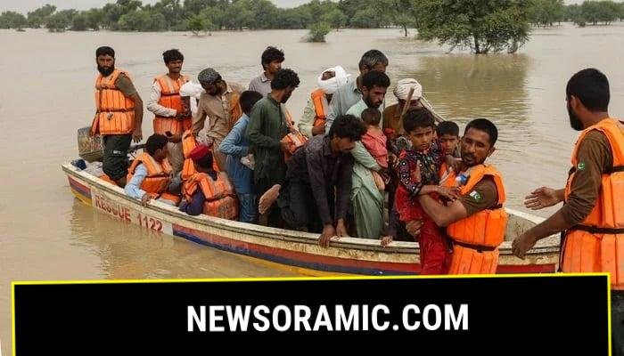 Rescue workers help to evacuate flood-affected people from their flood-hit homes following heavy monsoon rains in the Rajanpur district of Punjab. — AFP/File