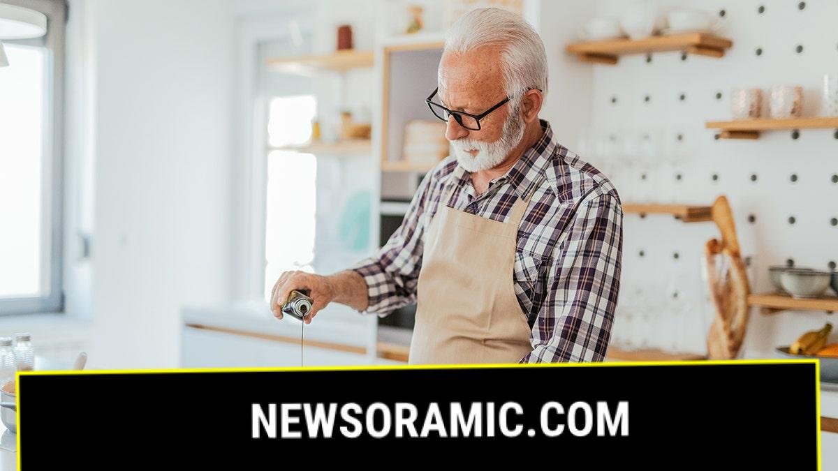 Man with gray hair at home cooking at home