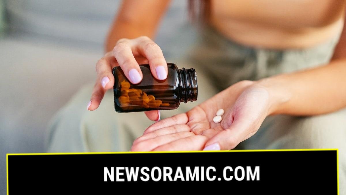 Woman pouring pills into hand