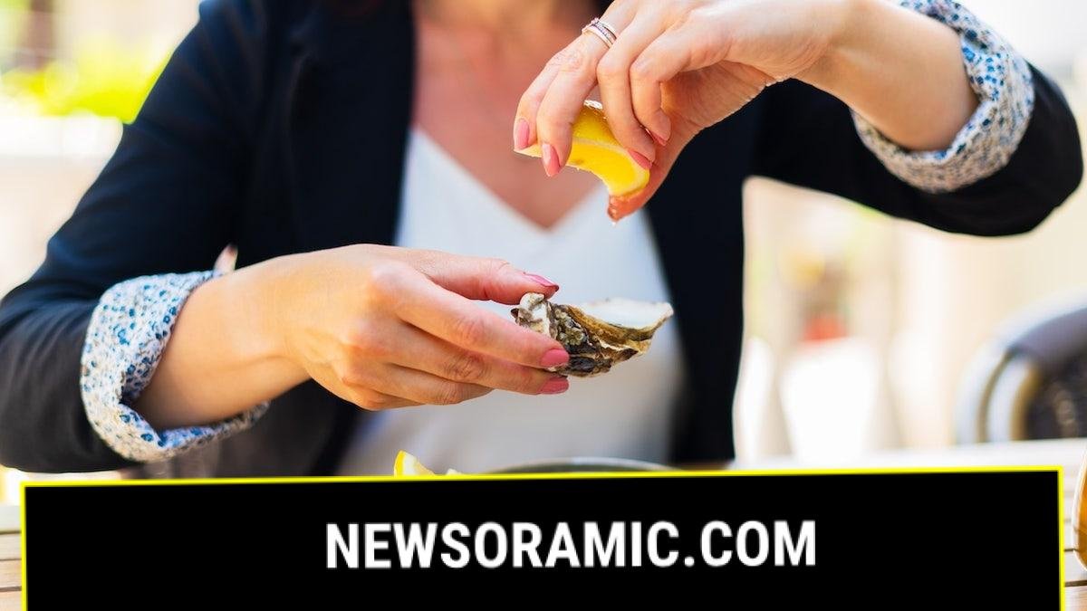 Woman eating raw oysters
