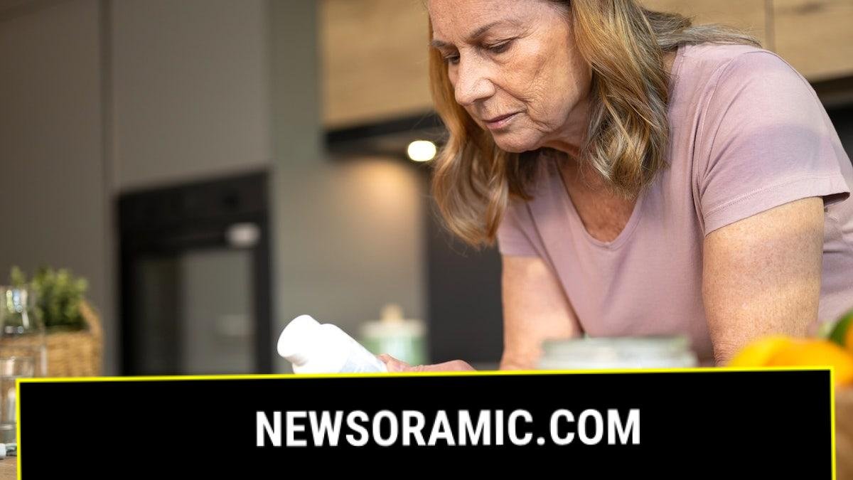 Woman looking at vitamin D bottle