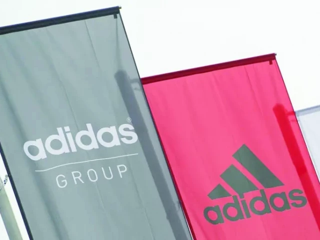 the logo of german sports brand adidas is pictured on waving flags in front of the adidas headquarters in herzogenaurach germany file lukas barth afp