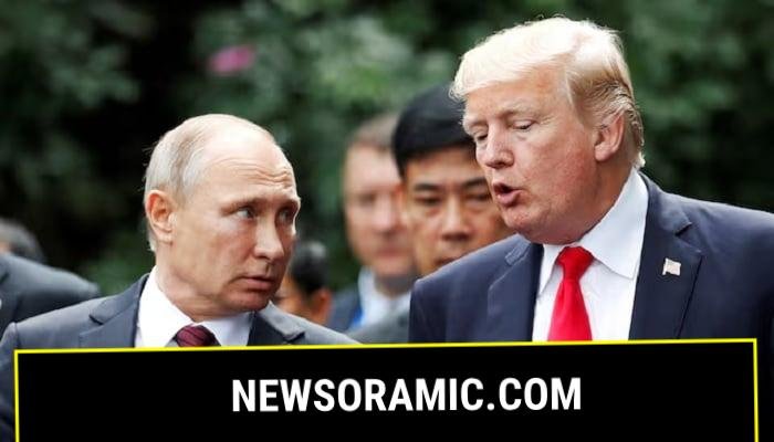 US President Donald Trump and Russias President Vladimir Putin talk during the family photo session at the APEC Summit in Danang, Vietnam, November 11, 2017. —Reuters
