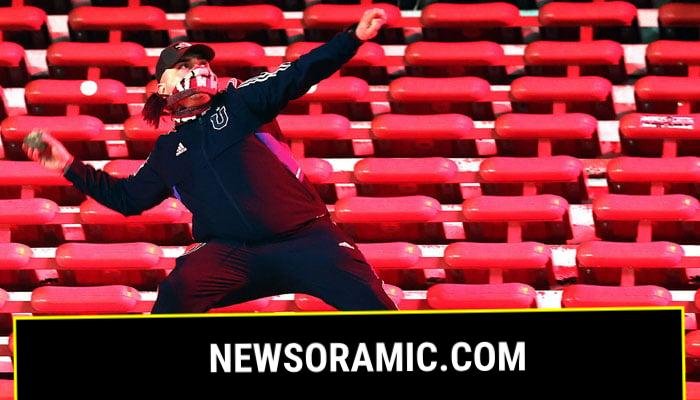A fan of Universidad de Chile prepares to throw a stone during the interruption of the Copa Sudamericana round of 16 second leg football match between Argentina’s Independiente and Chile’s Universidad de Chile at the Libertadores de America stadium in Avellaneda, Buenos Aires province, Argentina on August 20, 2025.