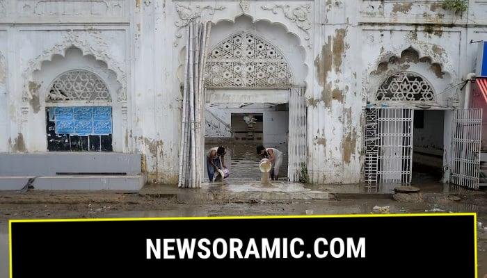 Men remove water from a mosque following heavy rain in Karachi, Pakistan, August 20, 2025.—Reuters