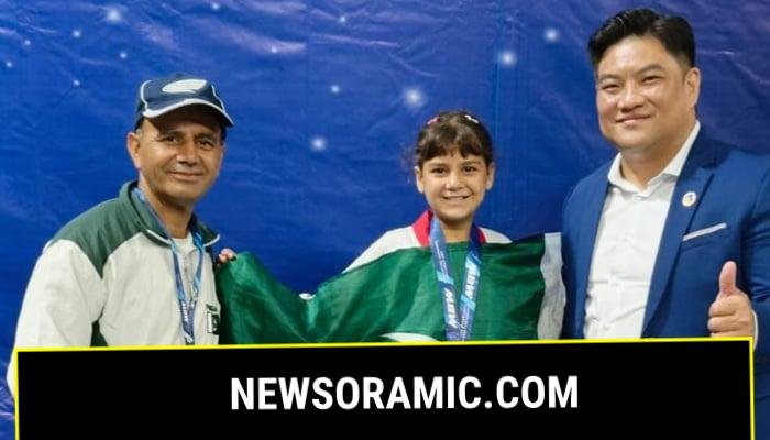 Pakistan’s youngest taekwondo champion Ayesha Ayaz receives her medal. — APP