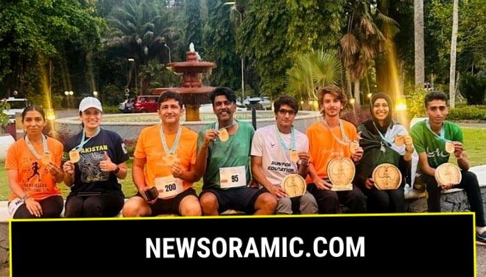 Pakistani journalist Raja Mohsin Ejaz (left) and Geo’s Deputy Sports Editor Faizan Lakhani (centre), along with other male and female participants, pose for a picture during the Seychelles Nature Trail Challenge 2025 at Mahé Island, Seychelles, on August 24, 2025. — Reporter