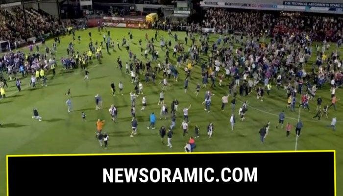The Grimsby fans are seen celebrating on the ground after their team knocked out Manchester United out of the English League Cup on August 28, 2025. — X@PolymarketFC