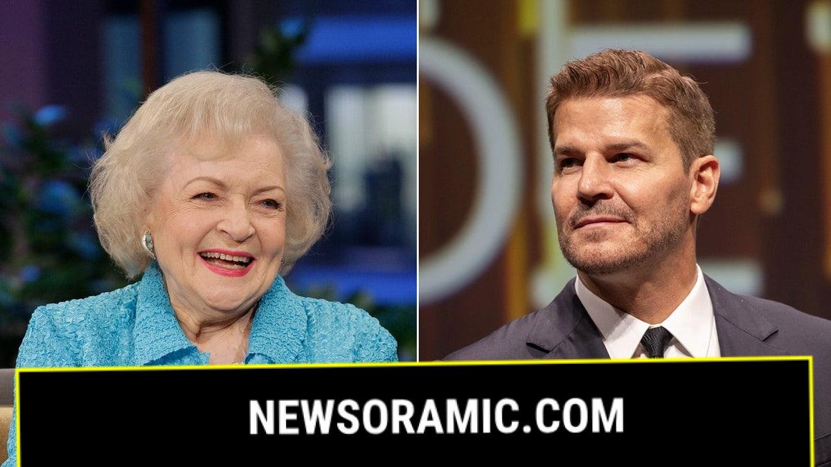 Betty White smiles wearing blue coat, David Boreanaz sports black suit.