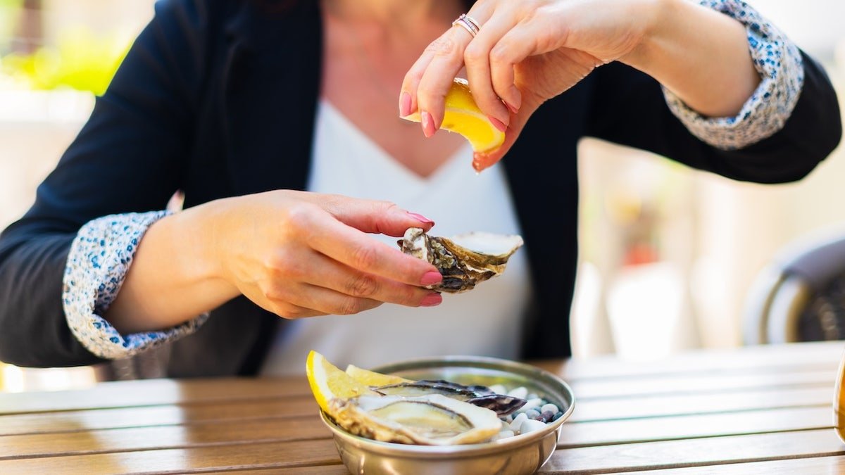 Woman eating raw oysters
