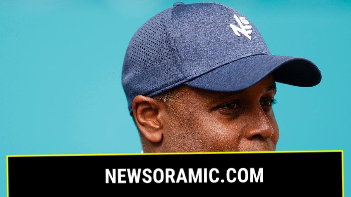 Chris Grier looks on