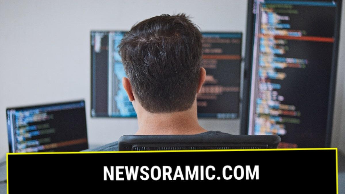 American man at computer screens