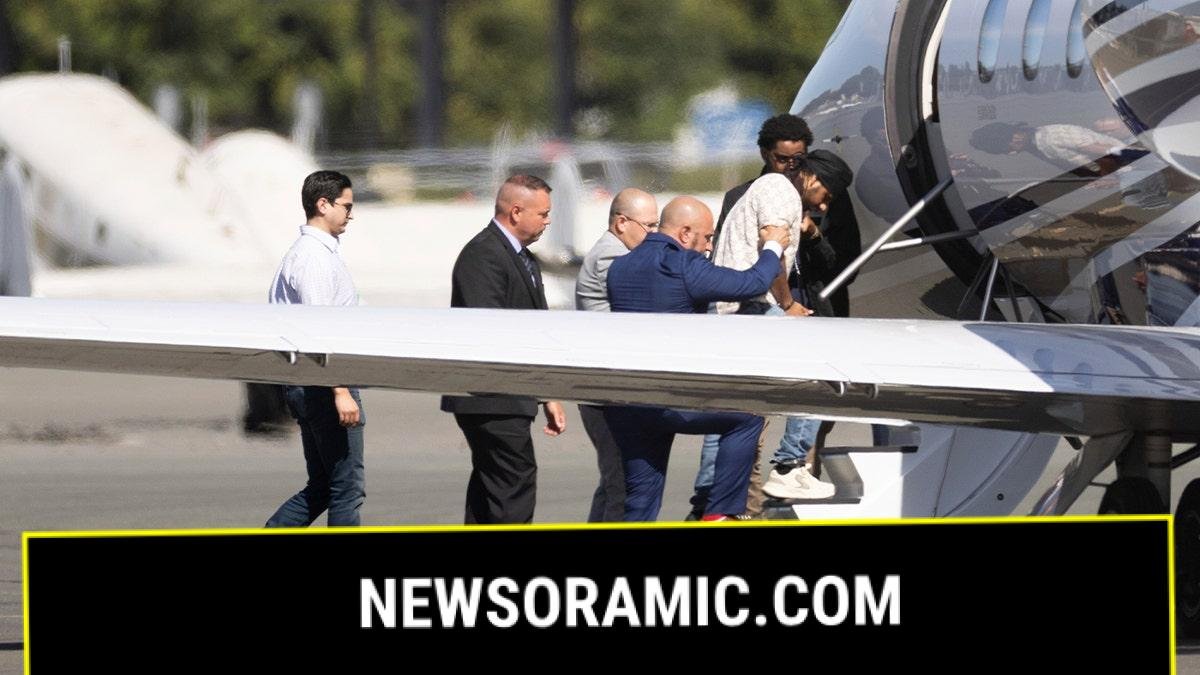 Harjinder Singh is escorted onto an airplane by Florida Lt. Gov. Jay Collins and law enforcement on Thursday, Aug. 21, 2025, in Stockton, Calif. 