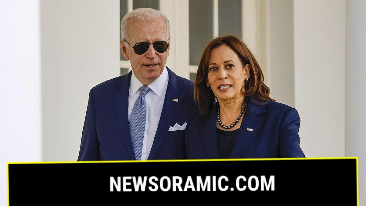 President Biden and Vice President Harris appear to be chatting as they walk through the Colonnade of the White House in Washington, D.C.