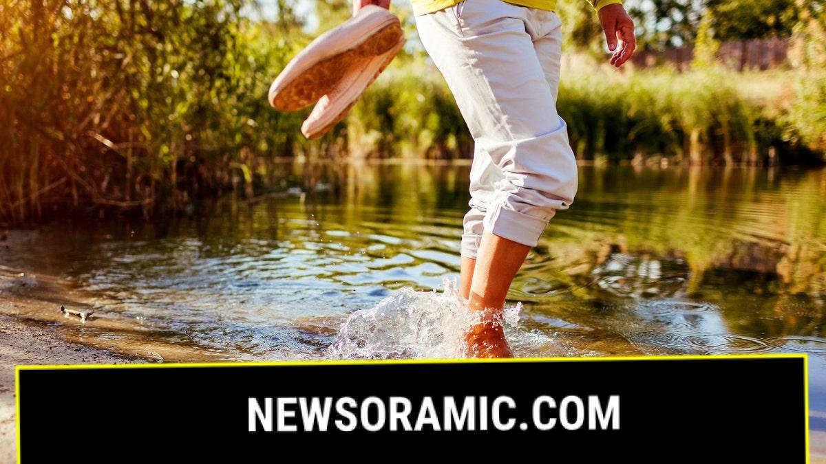 Woman wading in shallow water