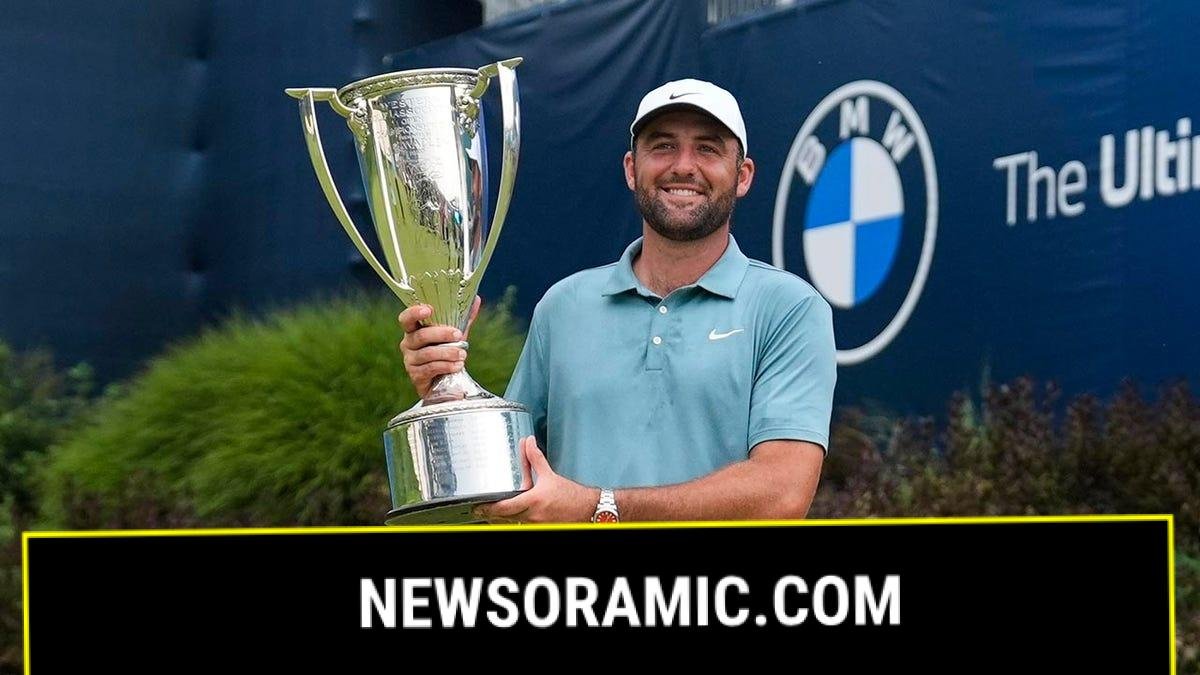 Scottie Scheffler holds trophy