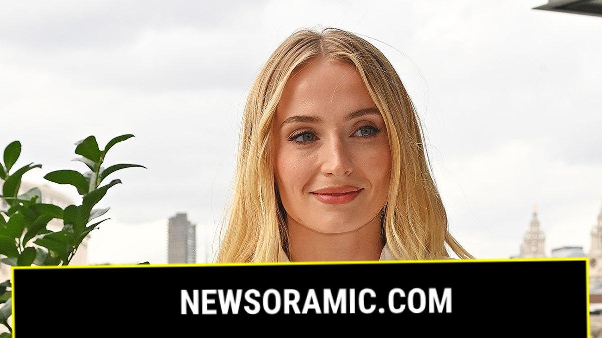 Sophie Turner wears white blouse with necklace