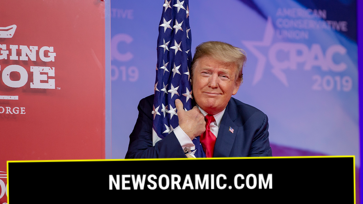 President Trump hugs U.S. flag