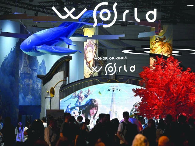 gamers wait at the honor of kings video game of tencent games during the gamescom video games trade fair at the trade fair center in cologne western germany the 2025 edition of the fair had its opening night on august 19 and will be running from august 20 to 24 photo afp