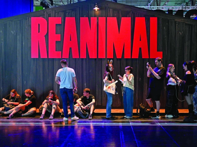 gamers wait at the reanimal video game of the tarsier studios during the gamescom in cologne photo afp
