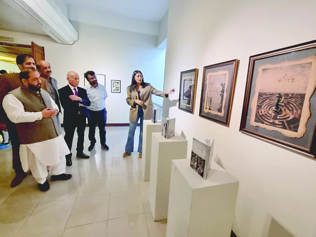 federal culture minister aurangzeb khichi and others admire art pieces on display at the shared distances exhibition at the pnca in islamabad photos app