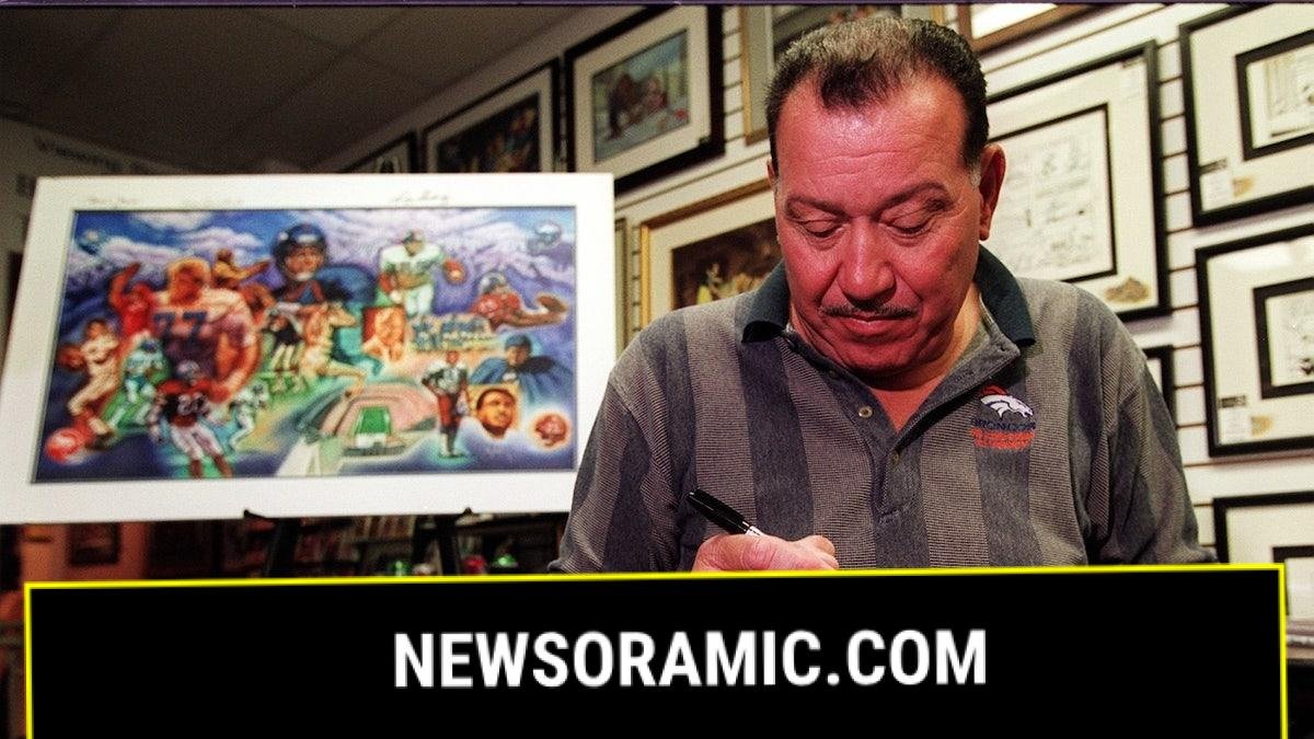 Lionel Taylor signs a helmet