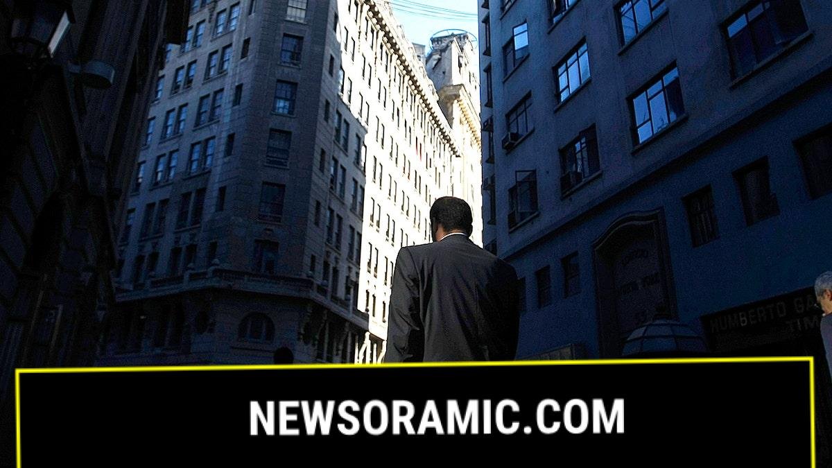 Men in suit walk through a financial district