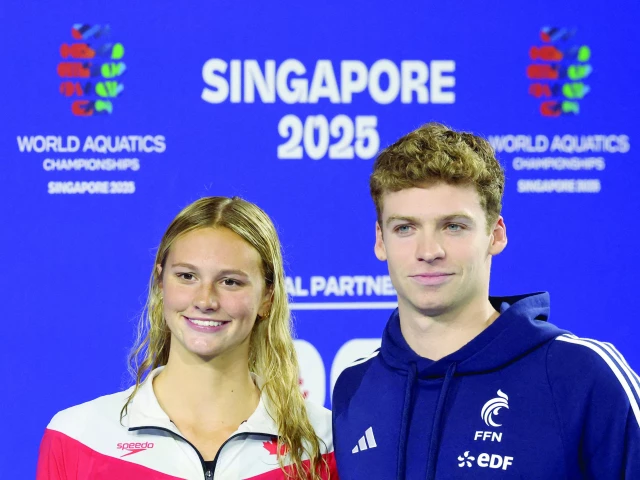 gold medallists canada s summer mcintosh and france s leon marchand pose after winning best female and male swimmer of the world aquatics championships photo reuters