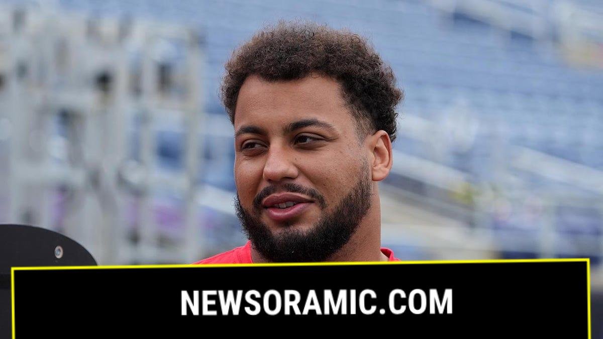 Rashawn Slater looks on field