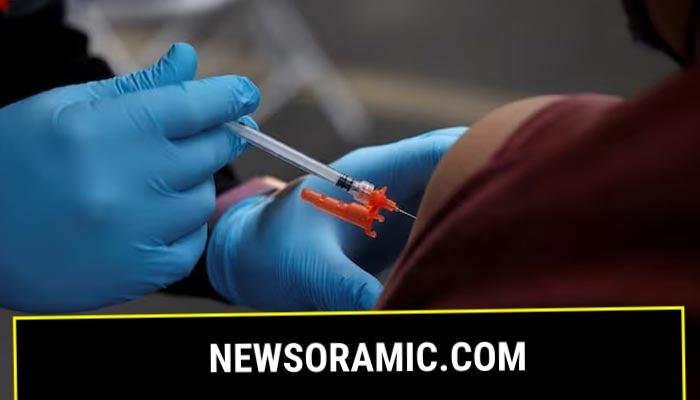 A health care administer gives the vaccine dose to a person in Los Angeles, California, US, January 29, 2022. Reuters