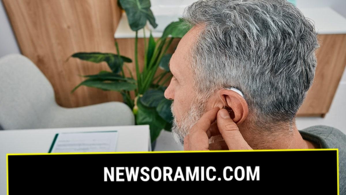 Man getting fitted with hearing aid