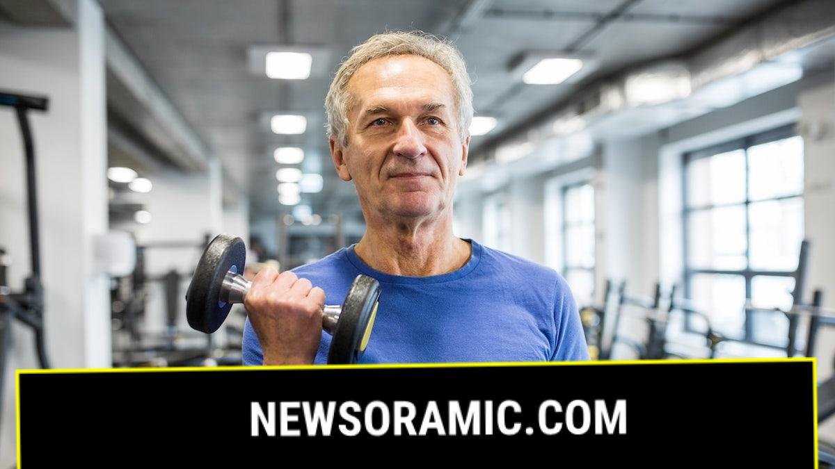 Older man lifting weights in gym