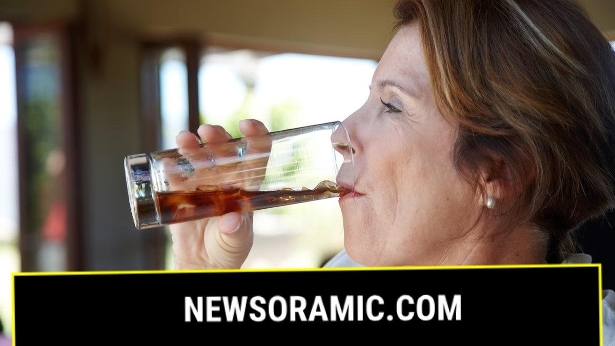 Older woman drinking soda