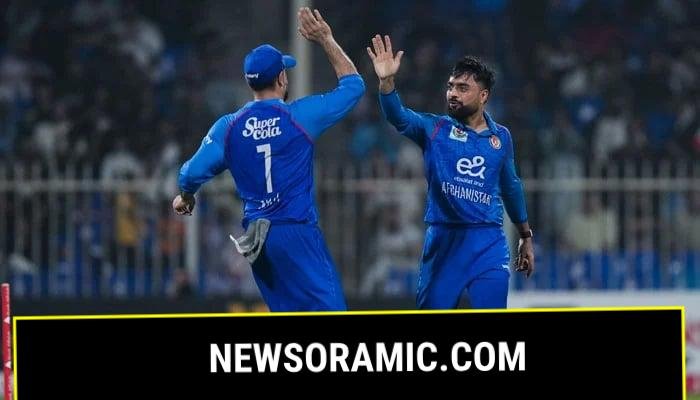 Afghanistans Rashid Khan (right) celebrates taking a wicket with Mohammad Nabi during their T20I tri-series match against Pakistan at the Sharjah Cricket Stadium in Sharjah on September 2, 2025. — Emirates Cricket Board