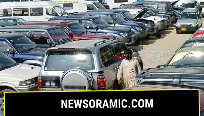 A employee of a car showroom walks amidst new cars displayed at an auto dealer centre in Karachi. — AFP/File