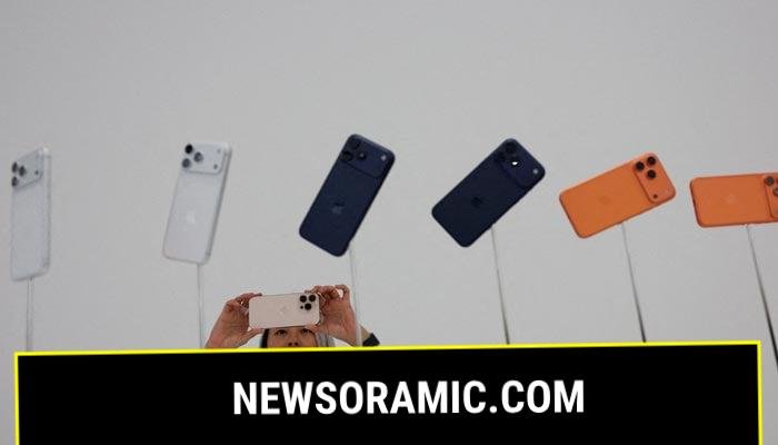 A woman takes pictures of iPhones during Apples event at the Steve Jobs Theatre in Cupertino, California, U.S., September 9, 2025. — Reuters