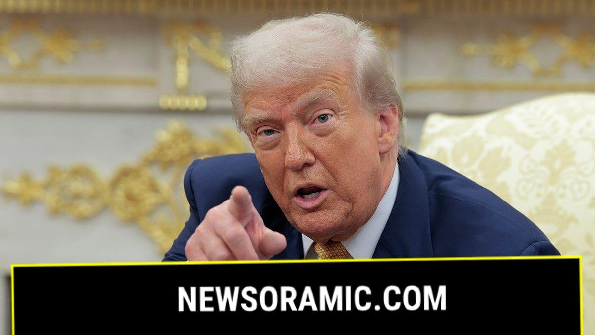 President Donald Trump pointing inside the White House.