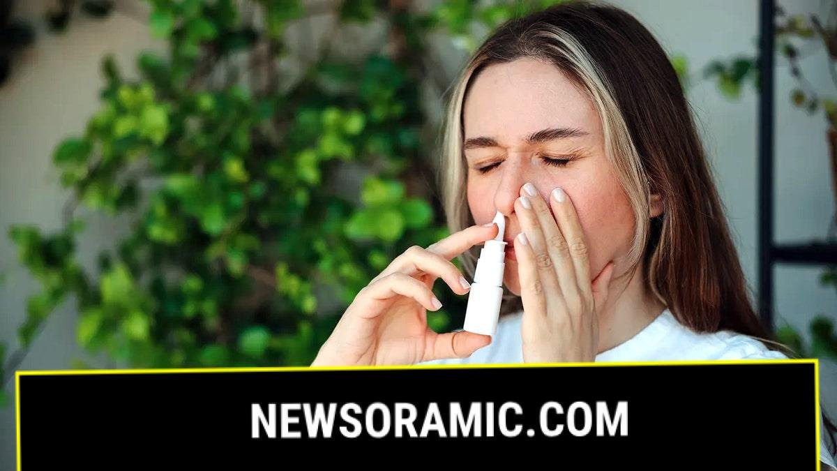 Woman using nasal spray