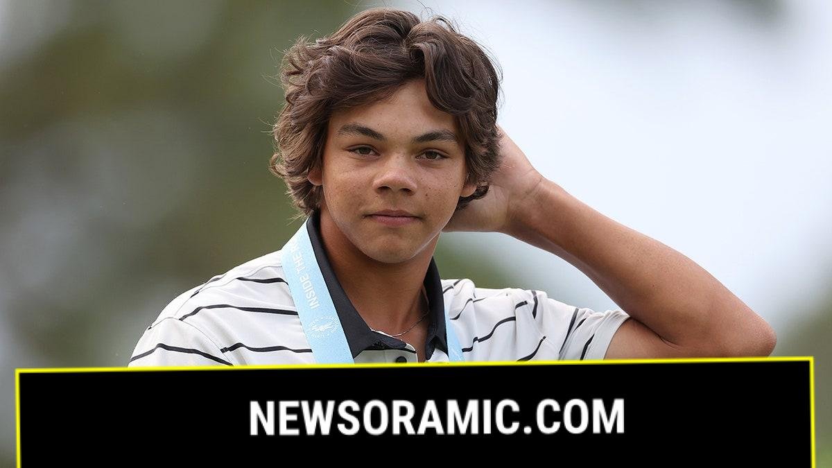 Charlie Woods looks on golf course