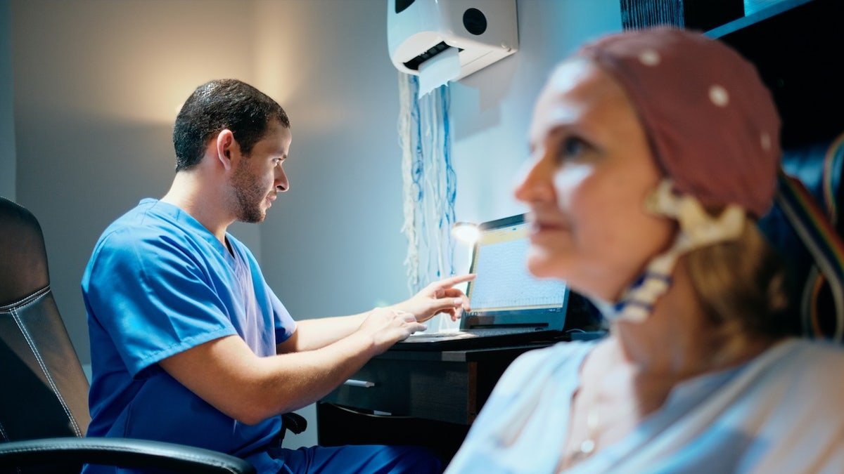 Woman getting EEG test with doctor