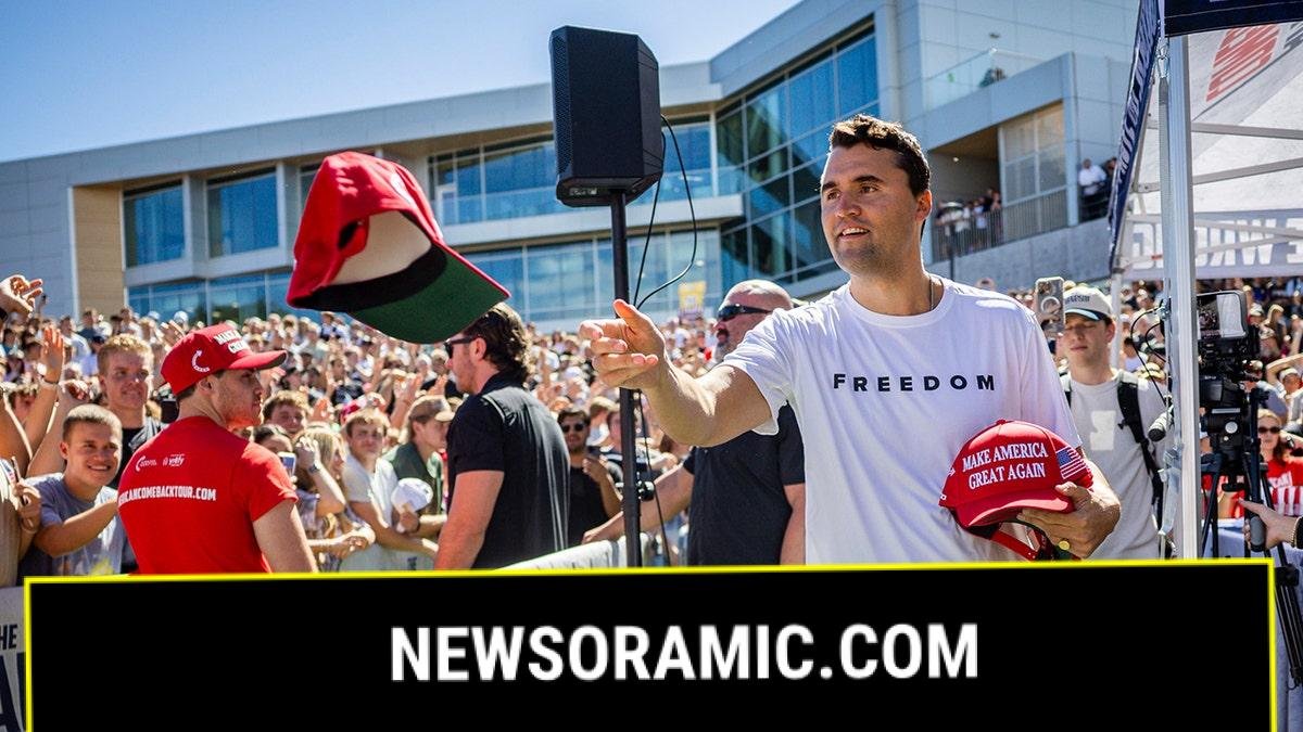 Charlie Kirk before he was shot hands out hats to the crowd