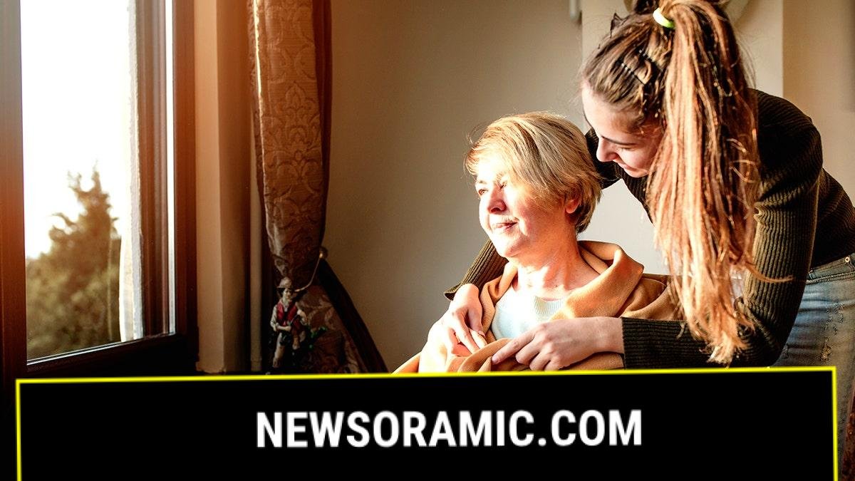 Woman caring for elderly adult with Parkinson's