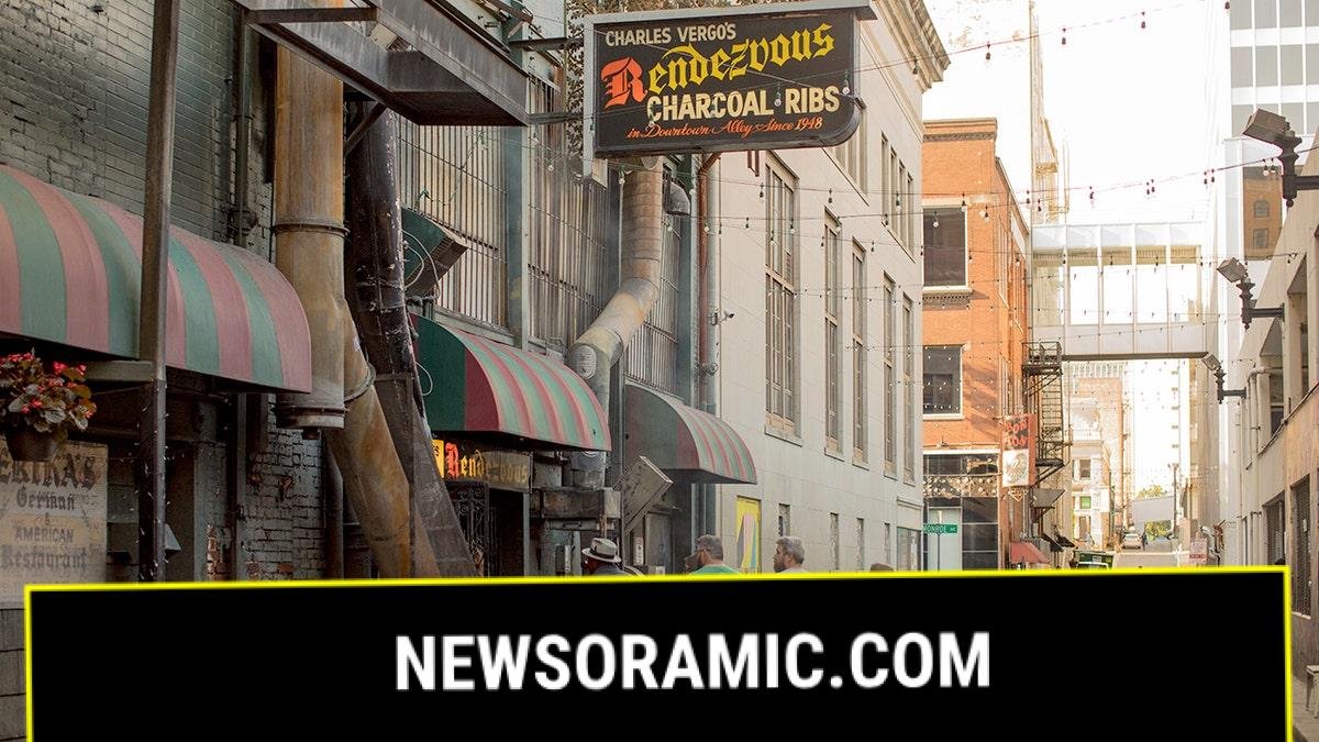 Four customers prepare to enter the Rendezvous restaurant, located in an alley in downtown Memphis.