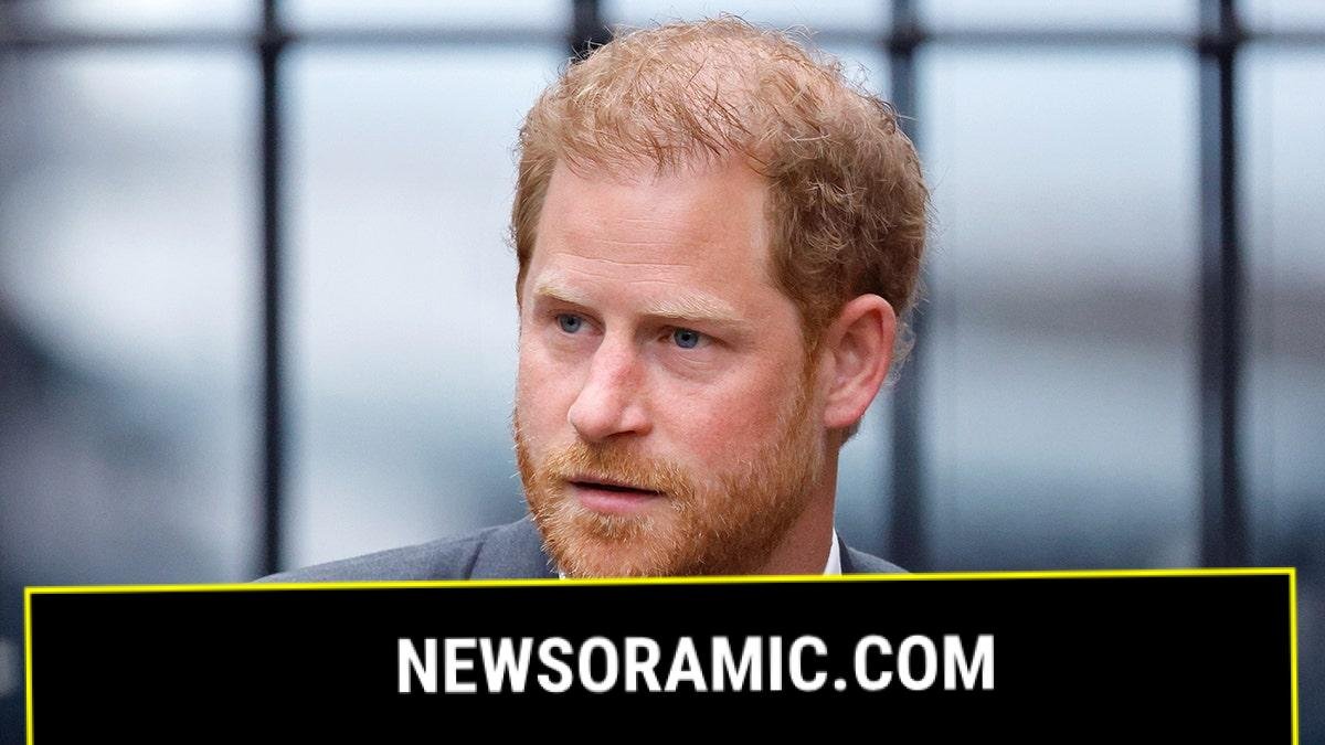 A close-up of Prince Harry in a grey suit